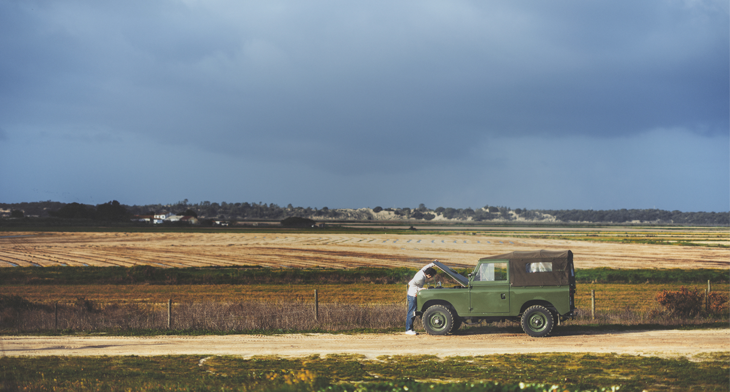 tom holland next to car in front of field