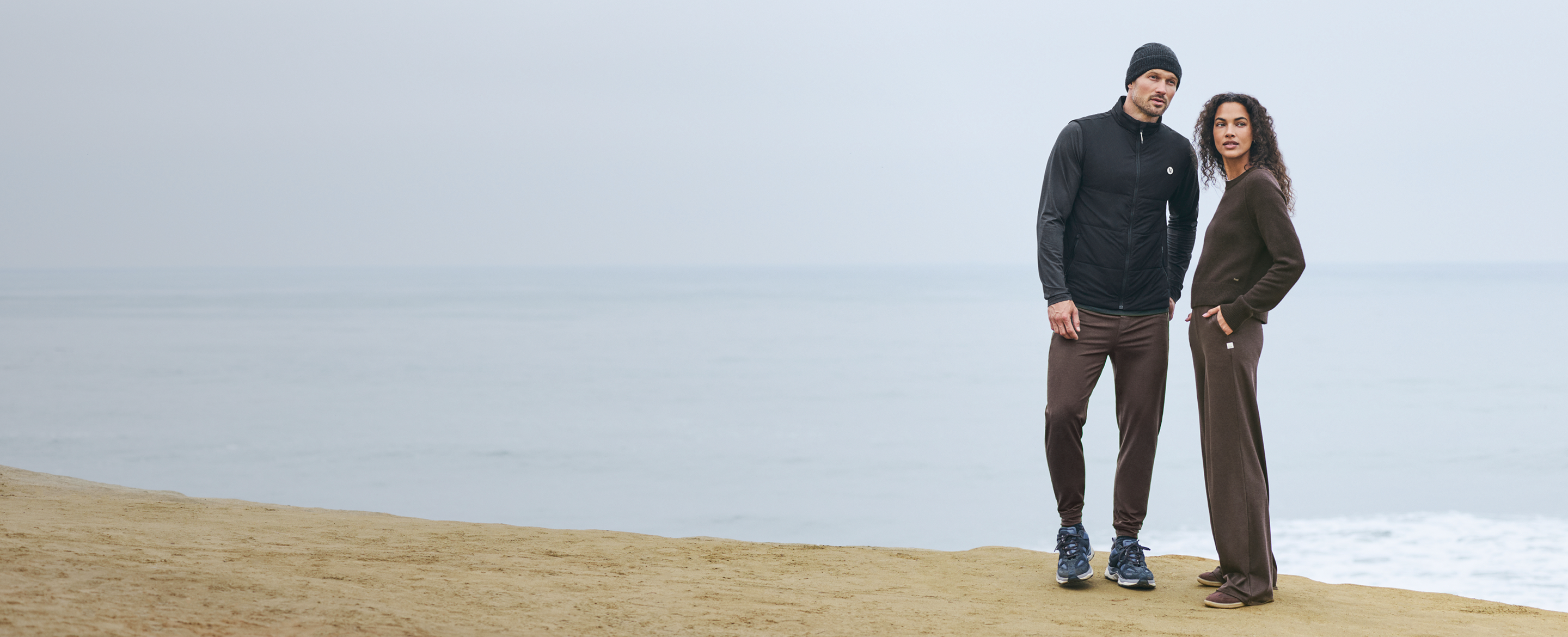 man and woman walking in vuori clothing