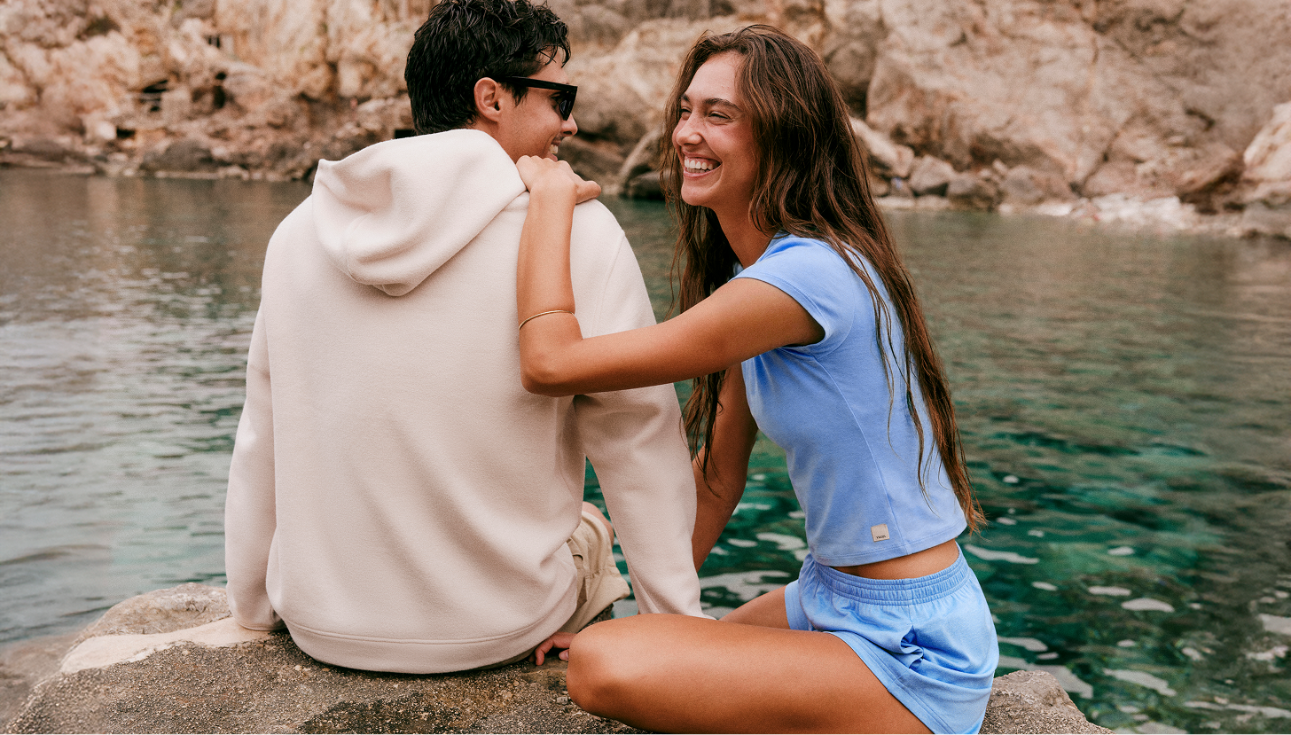 man and woman wearing vuori clothing outside