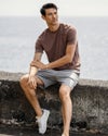 Man wearing strato tech tee in clove heather and ponto short