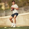 Arch Manning throwing a football