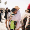 people hugging on the beach