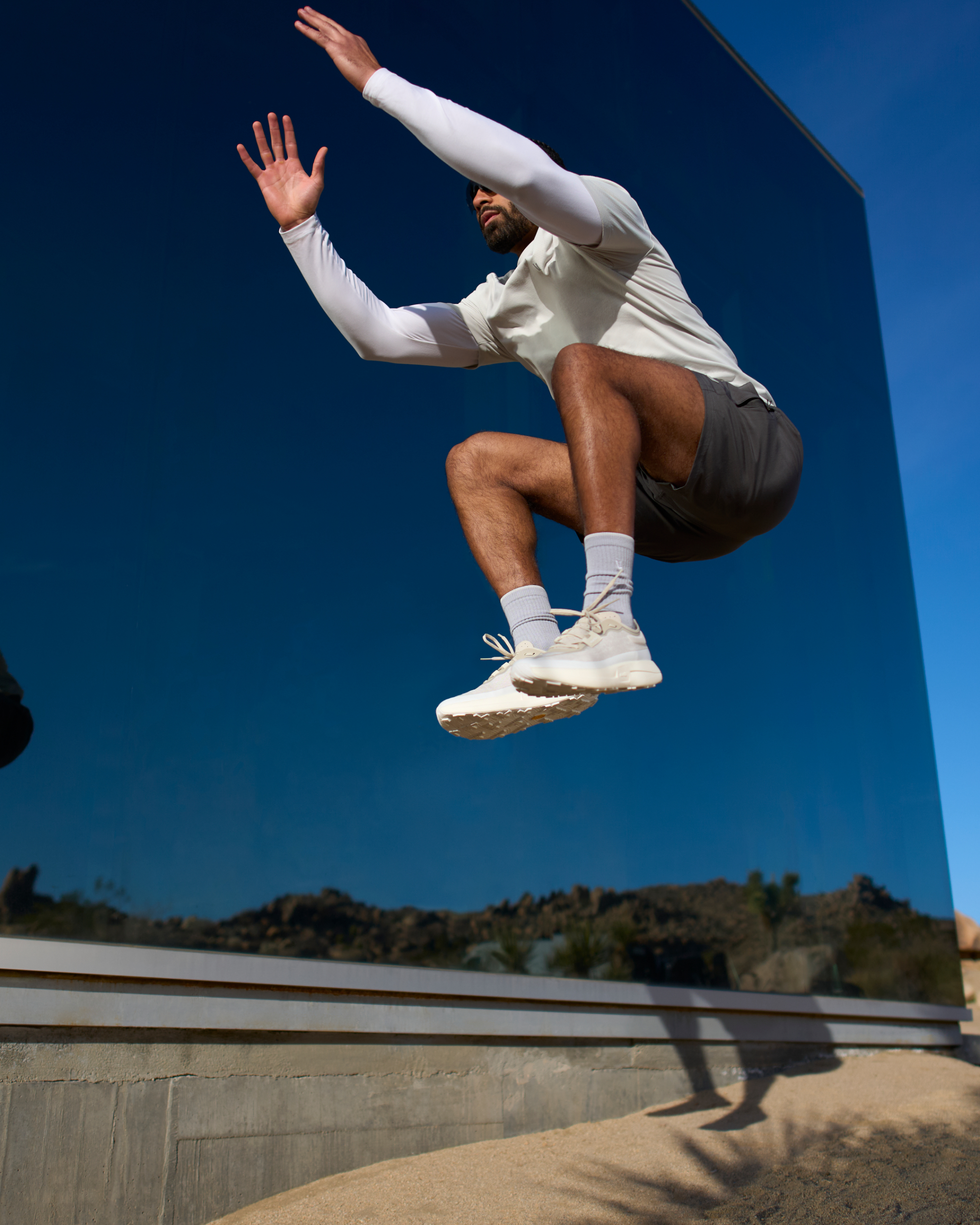 man wearing vuori doing high jumps