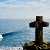 cross in front of ocean