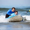 man helping girl surf