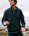 man with a golf club wearing vuori