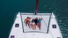 dylan efron with group of friends lounging on catamaran in the bahamas