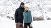 man and woman in snow wearing vuori outerwear