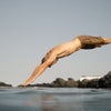 man diving into the water wearing the knox boardshort