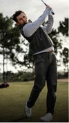 Tom Holland teeing off in the Vuori Aim Pant