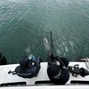 oceana divers sitting on the back of a boat