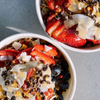 2 acai bowls topped with granola and mixed berries