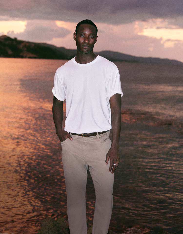 man wearing vuori clothing in front of sunset