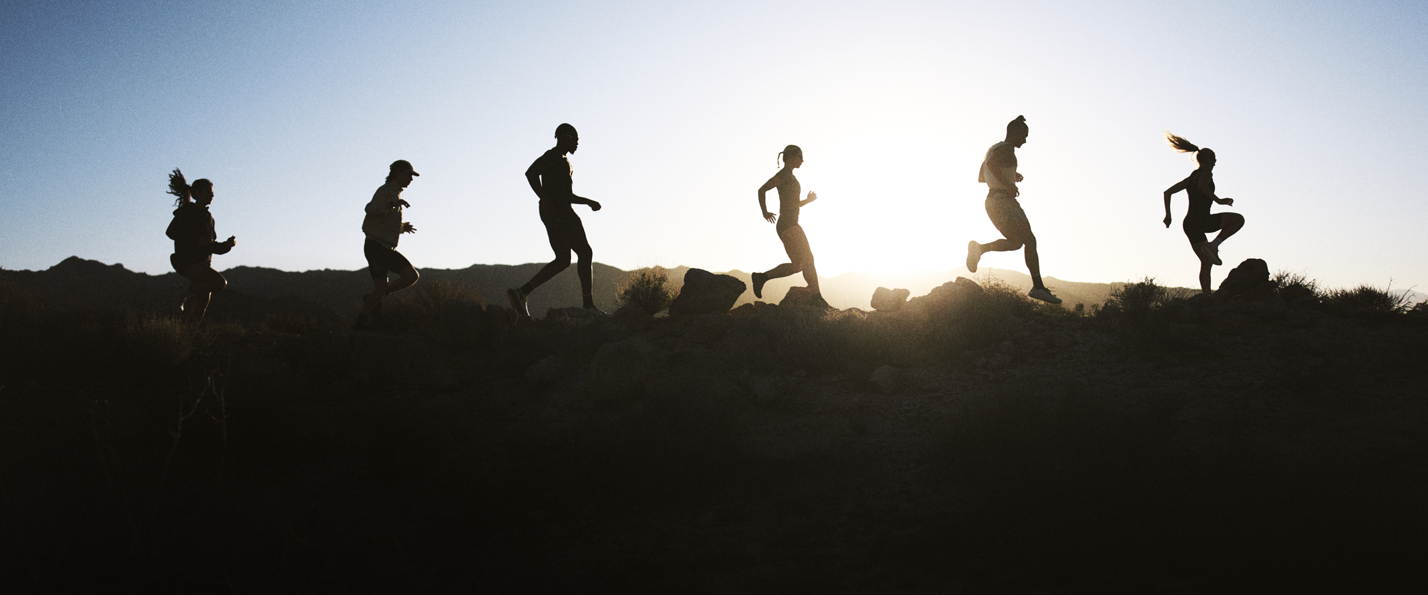 group of men and woman running outside