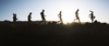 group of men and woman running outside