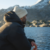 man looking out over lofoten harbor