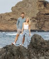 man and woman wearing vuori standing on reef rock