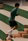 man wearing vuori terrain running shorts