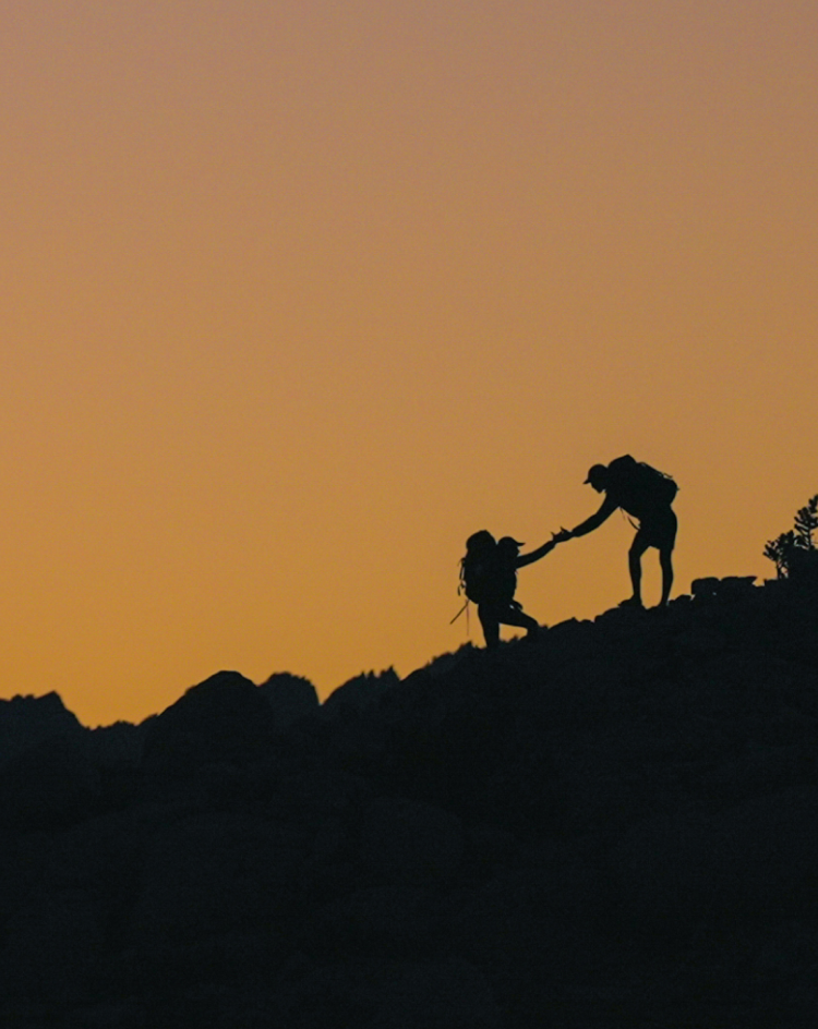 people hiking during sunset