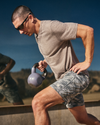 man wearing vuoring lifting a kettlebell