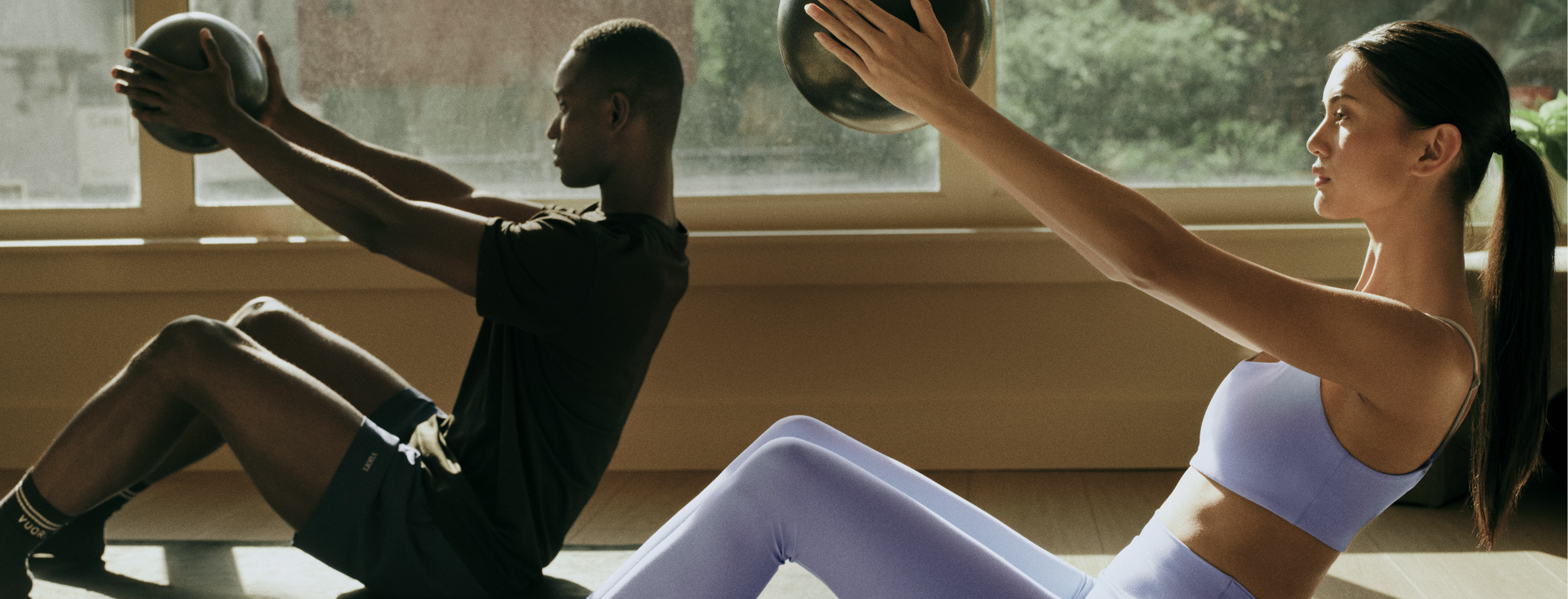 man and woman training in vuori clothing
