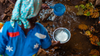 malawi woman filling pots with water