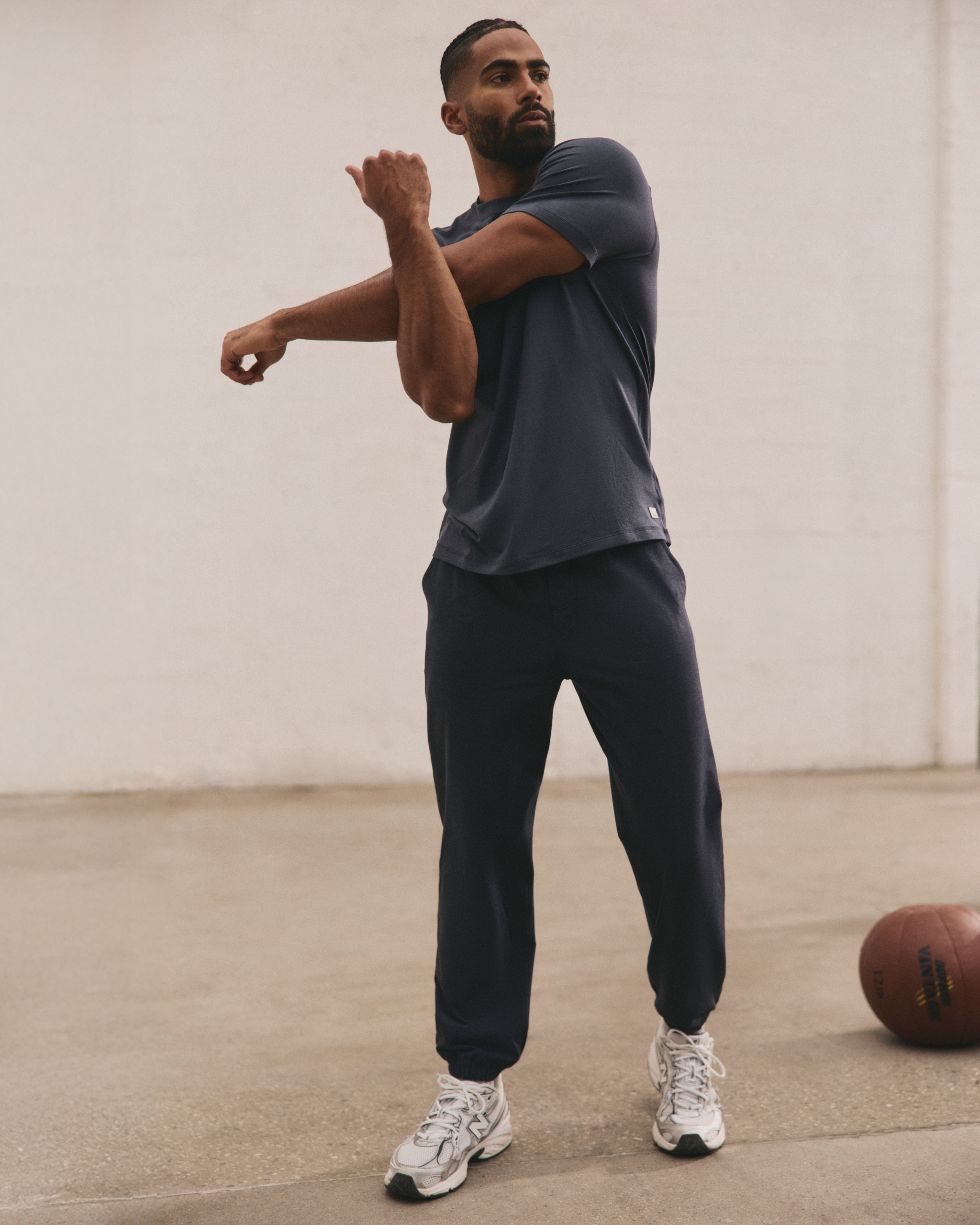 man wearing vuori stretching