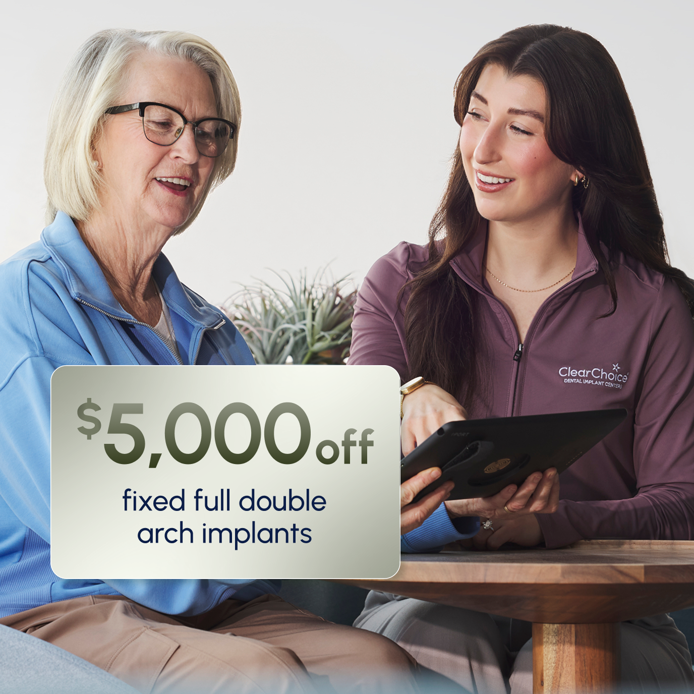 ClearChoice team member explaining the $5,000 off Insurance Assurance discount for fixed double arch implants to a patient