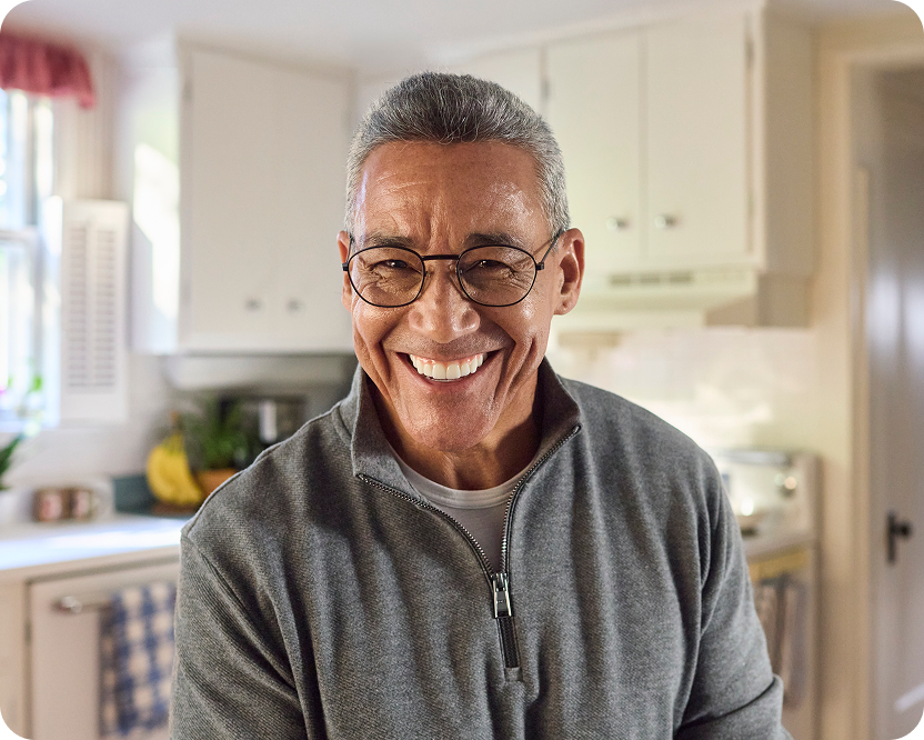 Alt text:
Smiling older man wearing glasses indoors.