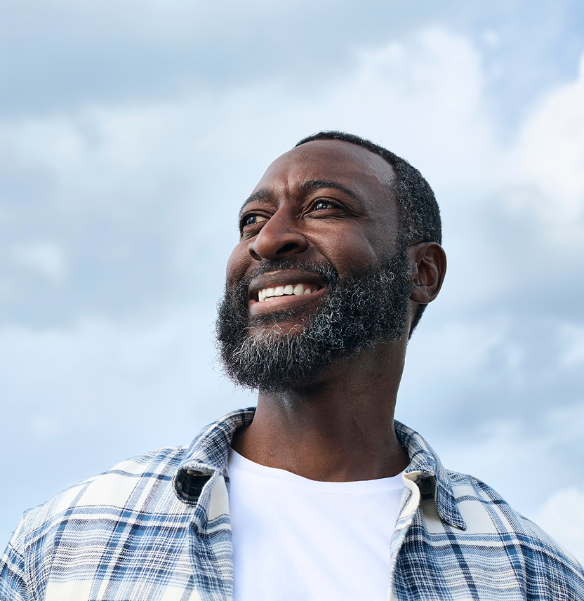 Alt text:
Confident man smiling outdoors, representing savings and special offers on dental treatment.