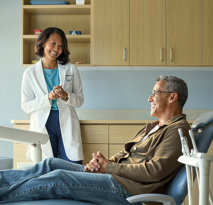 Aspen Dental dentist discussing treatment options with a patient during a dental appointment.