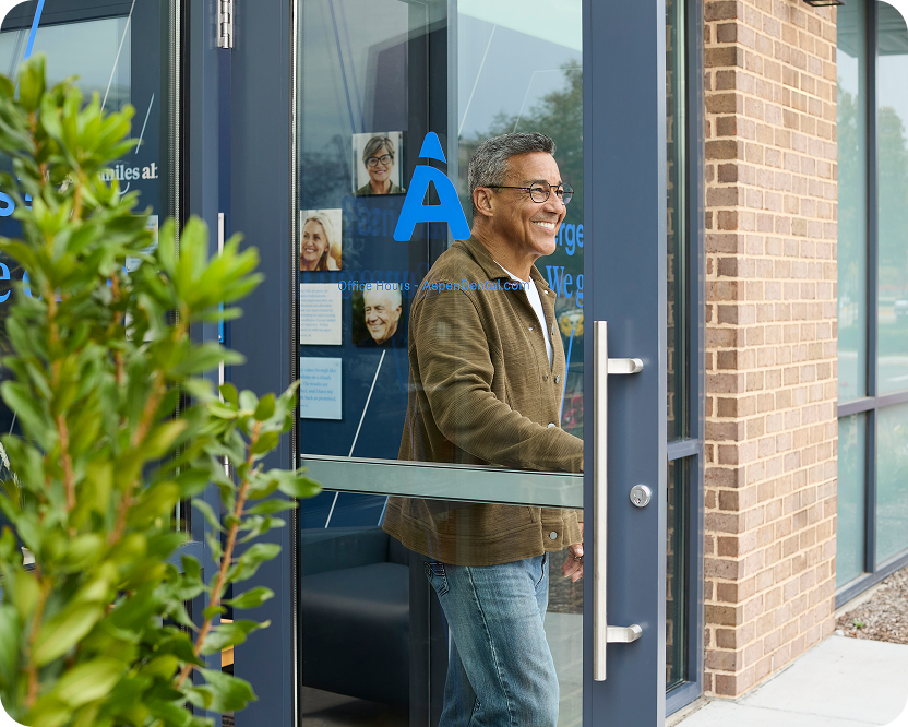 Alt text:
Man leaving an Aspen Dental office with a smile.