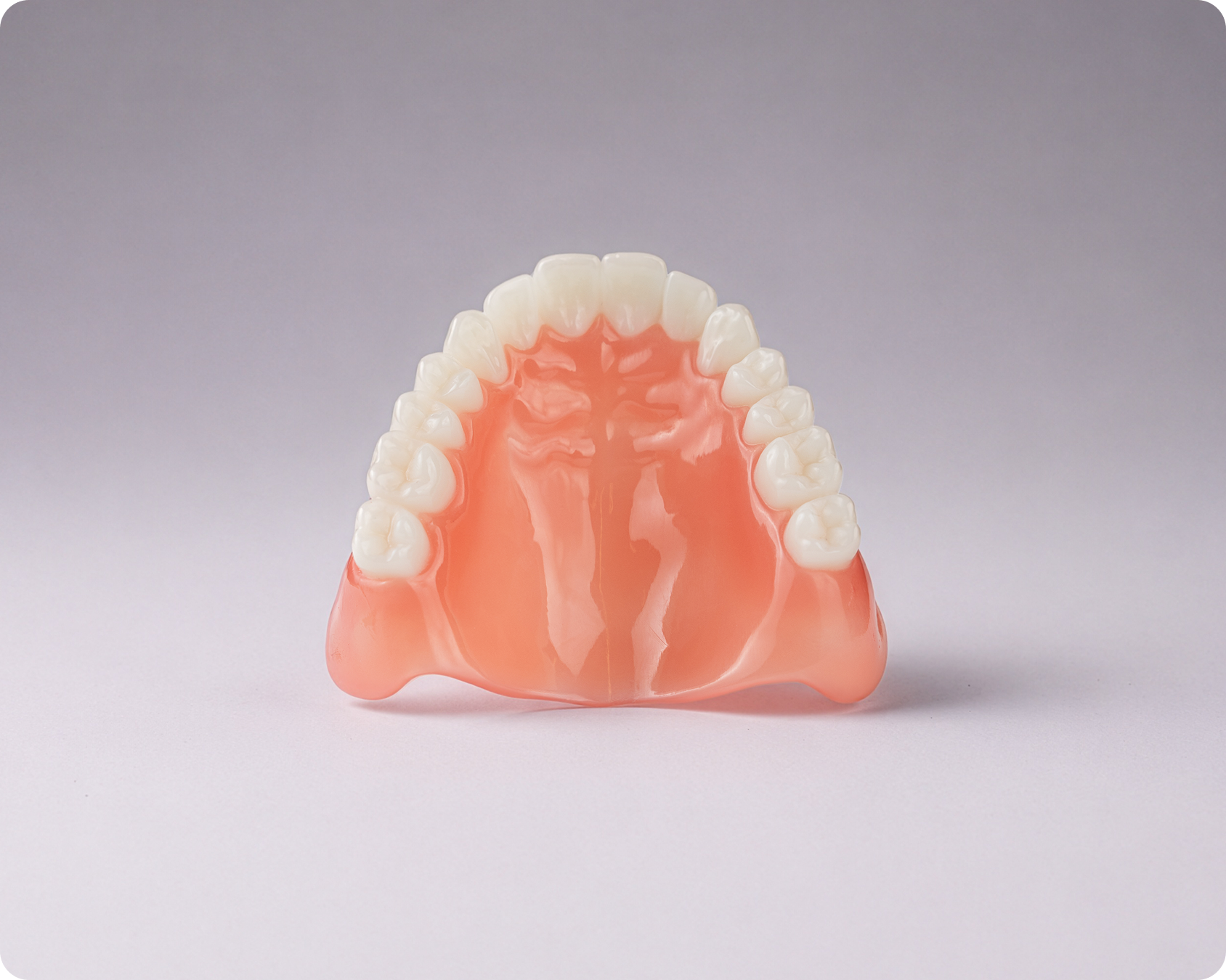 A full Signature upper denture highlighting the roof of the mouth view against a gray background