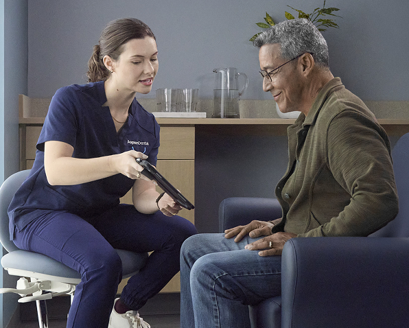 A healthcare professional consults with a patient using a tablet