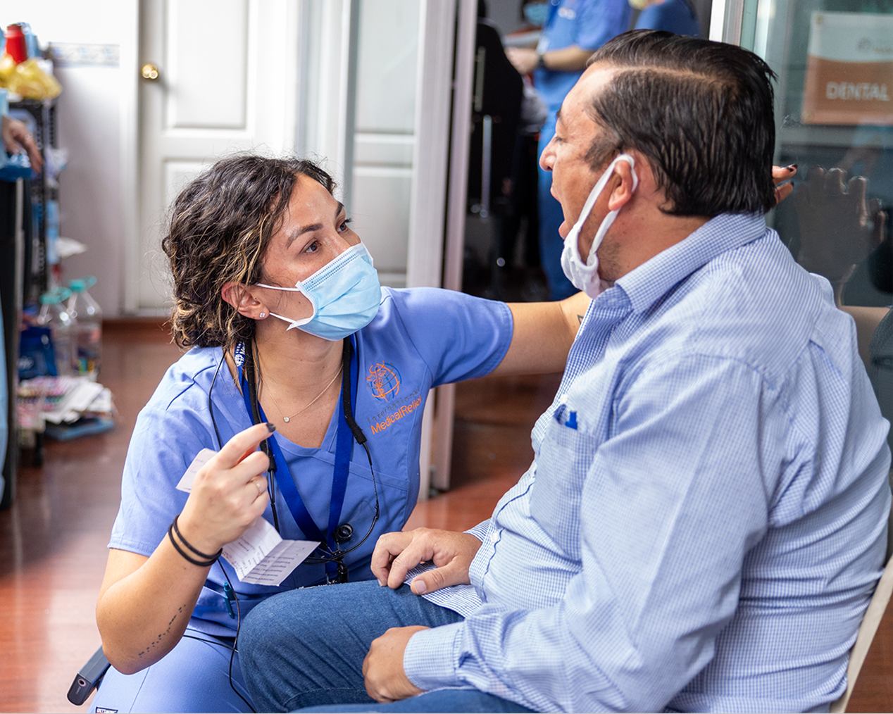 Alt text:
Dental professional speaking with a male patient during a consultation inside an Aspen Dental office.