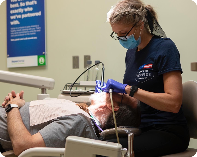A dental professional provides care to a patient