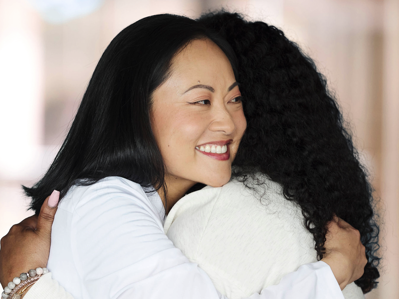 Friendly ClearChoice doctor in a white lab coat smiling during a patient consultation