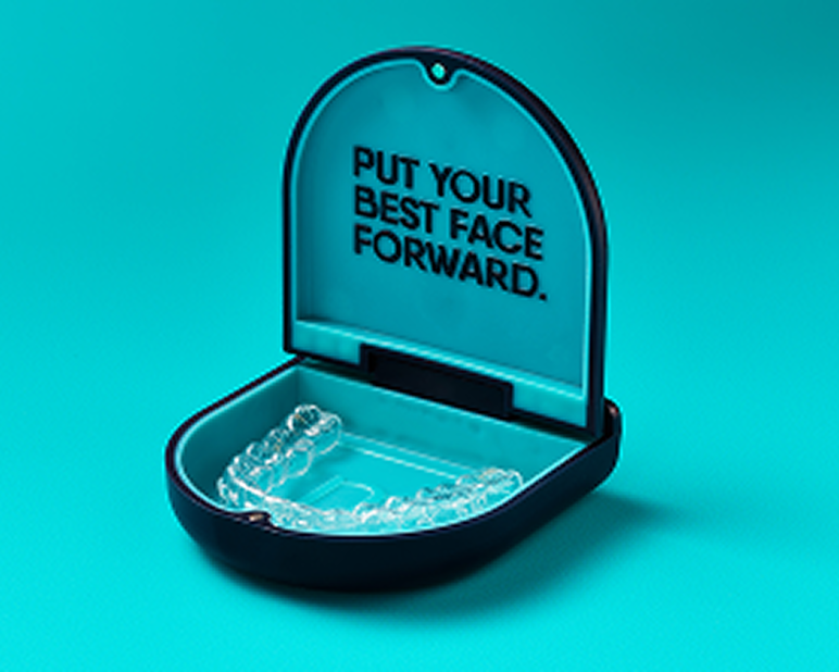 alt text: Close-up image of an open clear aligner case showing transparent orthodontic trays.