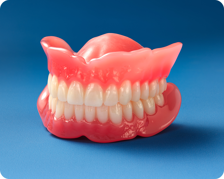 Signature Elite upper and lower denture model with pink gum base on a blue background.