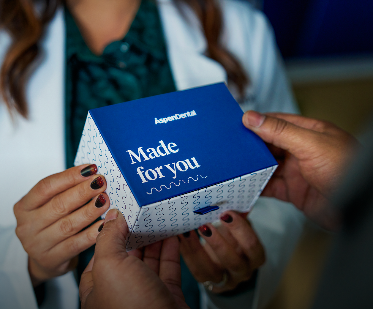 Hands exchanging a personalized "made for you" box