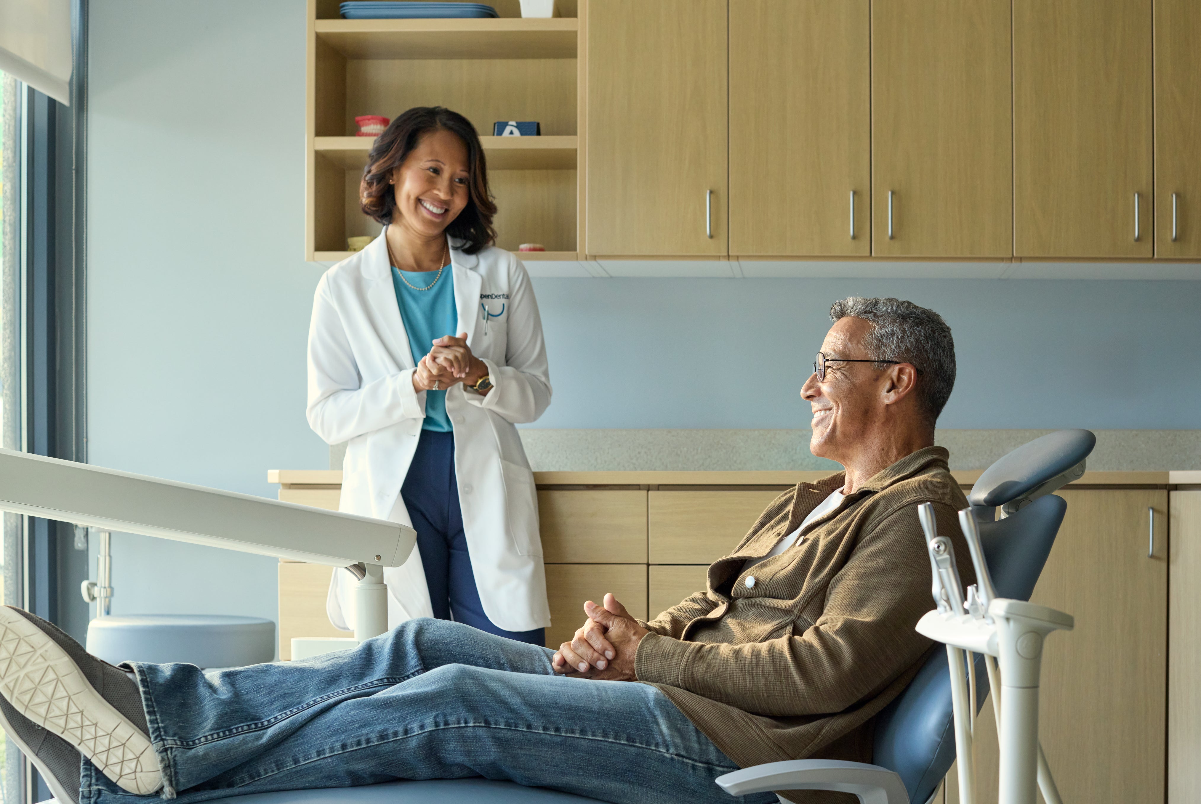 A dentist and patient having a friendly conversation