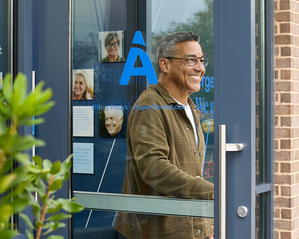 Patient leaving an Aspen Dental office with a smile.