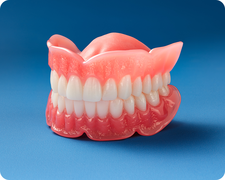 Signature full upper and lower denture model with pink gum base on a blue background.