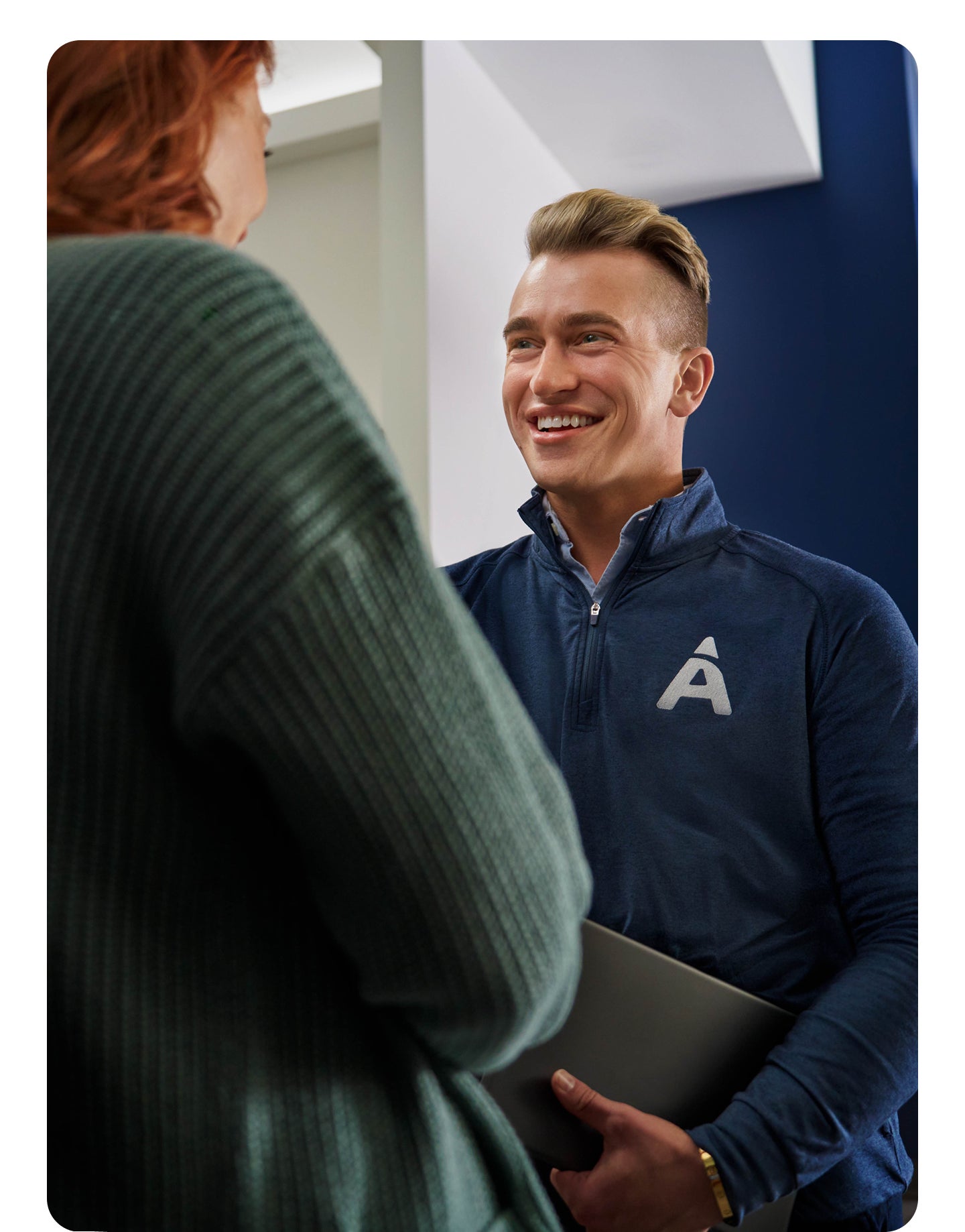 Aspen associate is greeting the patient as they come into the office for an appointment.