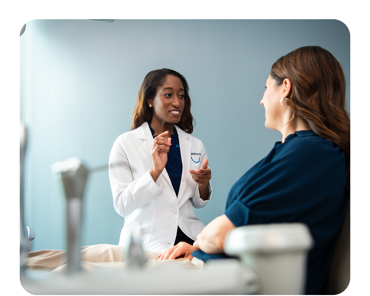 A dental professional consults with a patient
