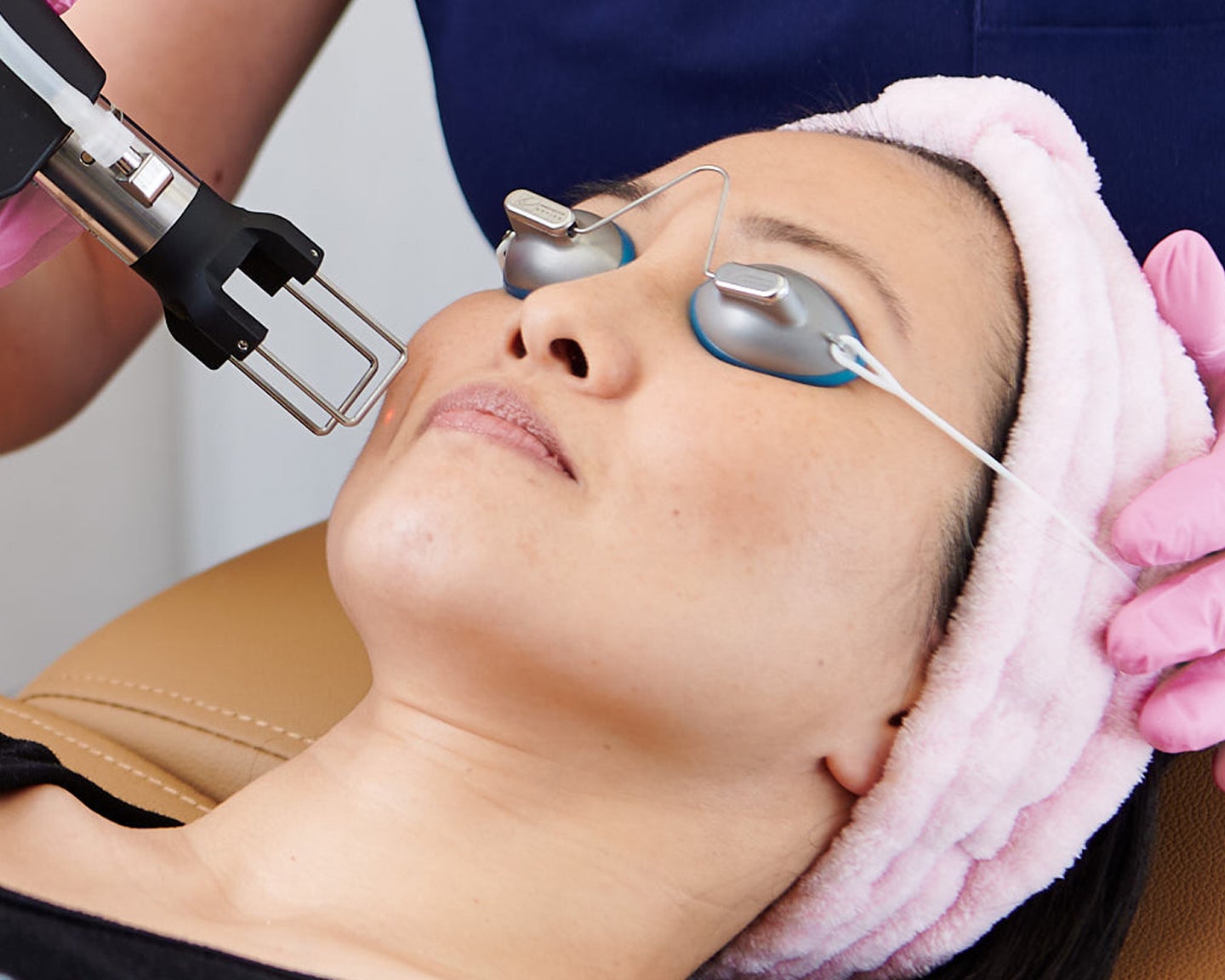A woman receives CO2 laser resurfacing at Chapter with protective eyewear, targeting skin texture, fine lines, and overall rejuvenation.