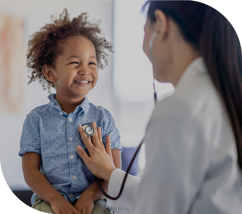 A doctor is listening to a young child 's heartbeat with a stethoscope
