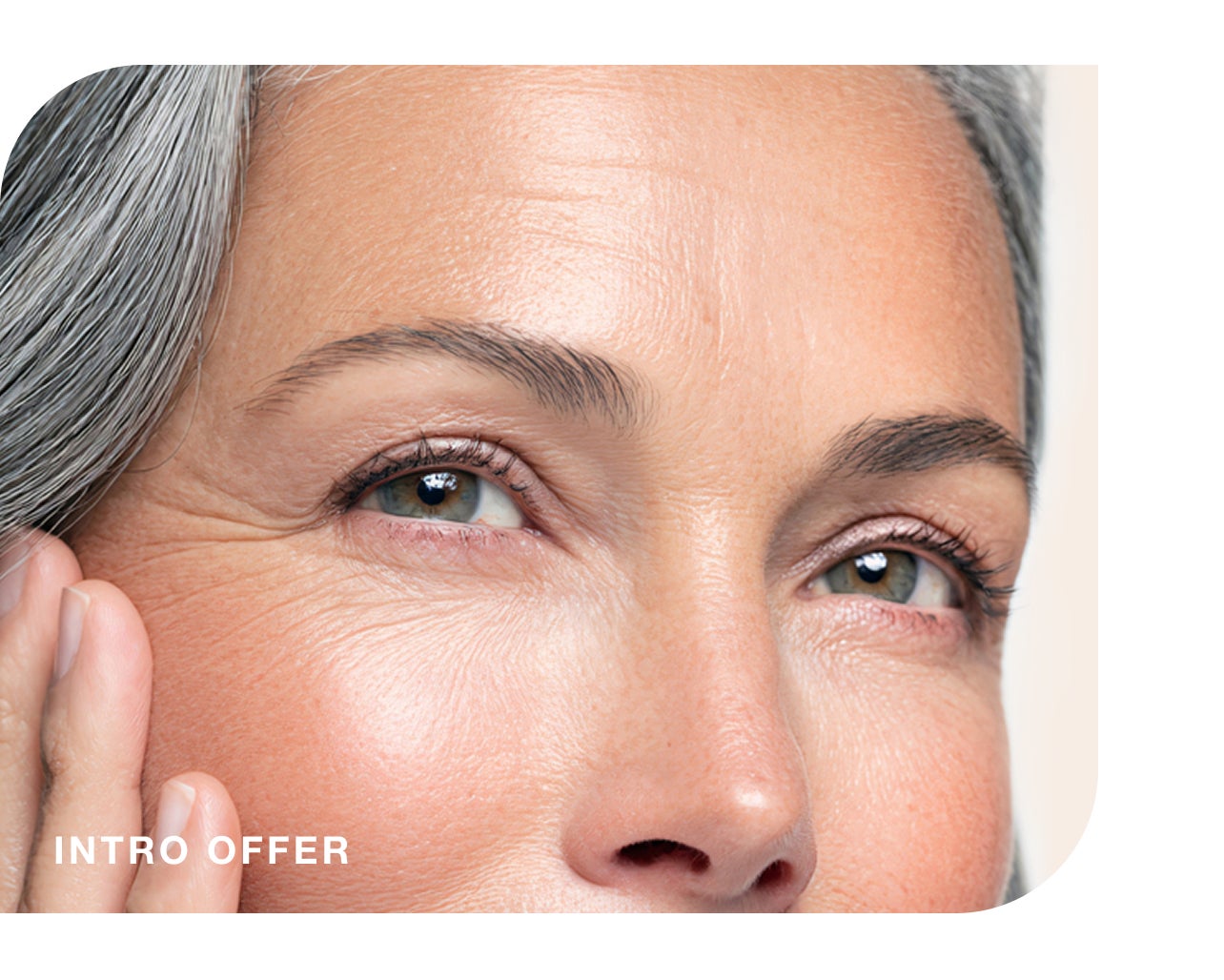Close-up of a mature woman's face with natural wrinkles, featuring an intro offer