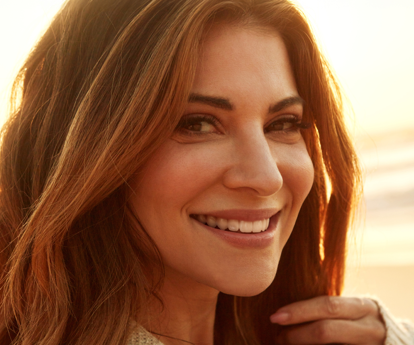 Smiling woman at sunset promoting Chapter’s summer offer: 30% off lasers, facials, peels &amp; more.