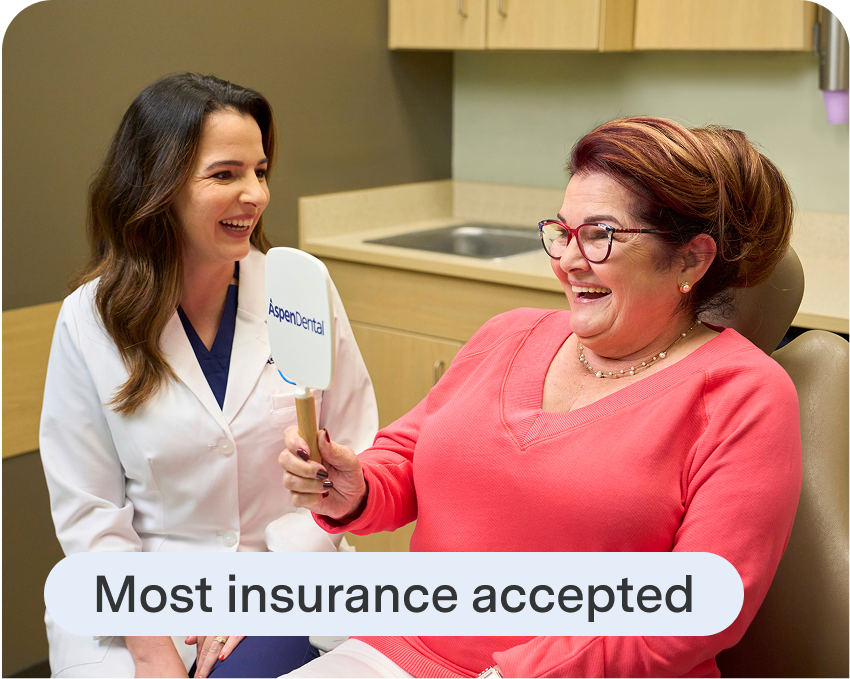 Aspen Dental staff explains insurance options during a dental implant consultation, reinforcing accessibility and patient-first care.